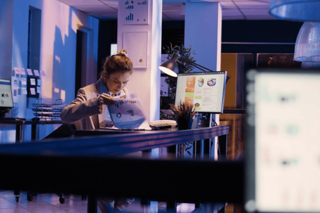 A person sitting at a desk looking at a computer screen.
